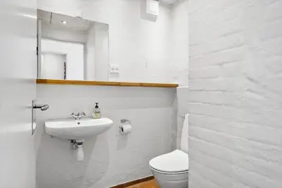 a white bathroom with a sink and a toilet at JB889-Brovst-Strandvejen-150-Lejl-130 in Brovst