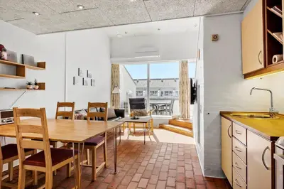 a kitchen and dining room with a table and chairs at JB889-Brovst-Strandvejen-150-Lejl-130 in Brovst