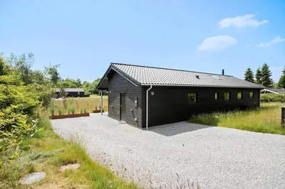 a black building sitting on top of a gravel driveway at JB164-Fjerritslev-Poppelvej-16 in Fjerritslev