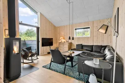 a living room with a couch and a table at JB164-Fjerritslev-Poppelvej-16 in Fjerritslev