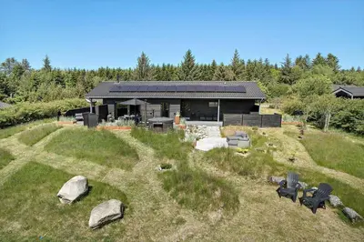a house on top of a hill with rocks at JB164-Fjerritslev-Poppelvej-16 in Fjerritslev