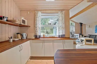 a kitchen with white cabinets and a window at JB136-Brovst-Harestien-1 in Brovst