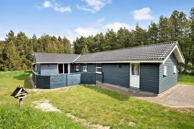 a blue house with a yard in front of it at JB136-Brovst-Harestien-1 in Brovst