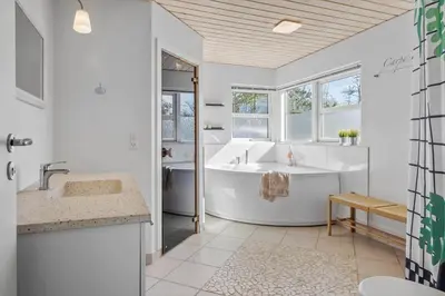 a white bathroom with a tub and a sink at JB299-Brovst-Kronvildtvej-224 in Brovst