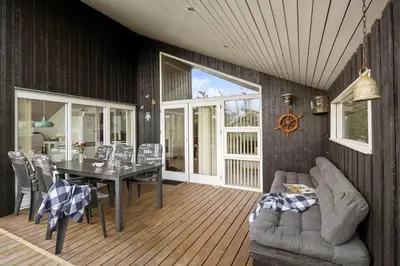a living room with a table and a couch at JB299-Brovst-Kronvildtvej-224 in Brovst