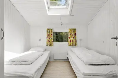 two beds in a white room with a window at JB236-Fjerritslev-Ahornvej-22 in Fjerritslev