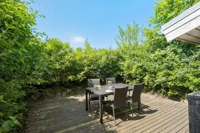 a table and chairs on a wooden deck at JB236-Fjerritslev-Ahornvej-22 in Fjerritslev