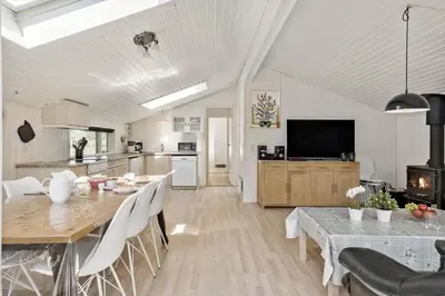 a kitchen and dining room with a table and chairs at JB236-Fjerritslev-Ahornvej-22 in Fjerritslev