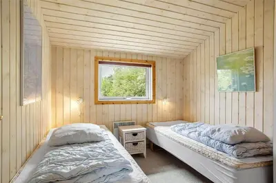 two beds in a room with a window at JB538-Fjerritslev-Tyttebaerstien-33 in Fjerritslev