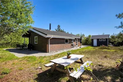 a cabin with a picnic table in front of it at JB538-Fjerritslev-Tyttebaerstien-33 in Fjerritslev