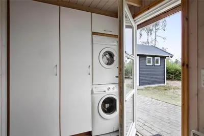 a washer and dryer in a house with a window at JB538-Fjerritslev-Tyttebaerstien-33 in Fjerritslev