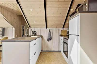 a kitchen with white appliances and wooden walls at JB229-Fjerritslev-Hasselvej-13 in Fjerritslev
