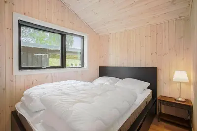 a large white bed in a room with a window at JB229-Fjerritslev-Hasselvej-13 in Fjerritslev