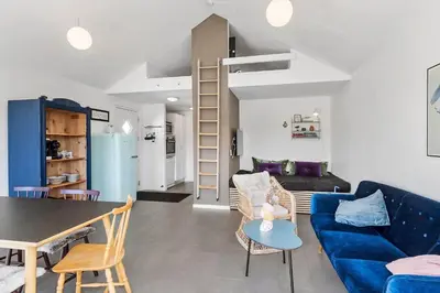 a living room with a blue couch and a table at JB302-Fjerritslev-Slettestrandvej-134-lejl-6 in Fjerritslev