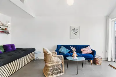 a living room with a blue couch and a table at JB302-Fjerritslev-Slettestrandvej-134-lejl-6 in Fjerritslev