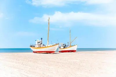 two boats sitting on the sand on a beach at JB302-Fjerritslev-Slettestrandvej-134-lejl-6 in Fjerritslev