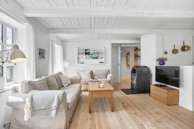 a living room with a couch and a tv at JB199-Fjerritslev-Svinklovvej-403 in Fjerritslev