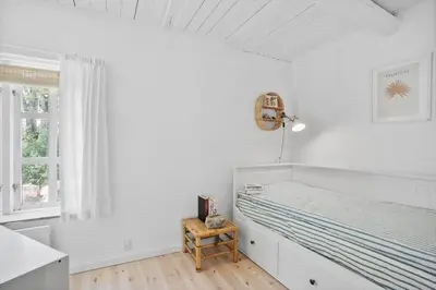 a white bedroom with a bed and a window at JB199-Fjerritslev-Svinklovvej-403 in Fjerritslev