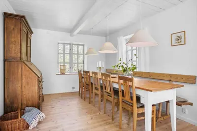 a dining room with a wooden table and chairs at JB199-Fjerritslev-Svinklovvej-403 in Fjerritslev