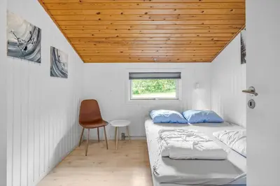 two beds in a room with a wooden ceiling at JB118-Fjerritslev-Ahornvej-8 in Fjerritslev