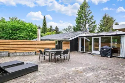 a patio with a table and chairs in front of a house at JB118-Fjerritslev-Ahornvej-8 in Fjerritslev