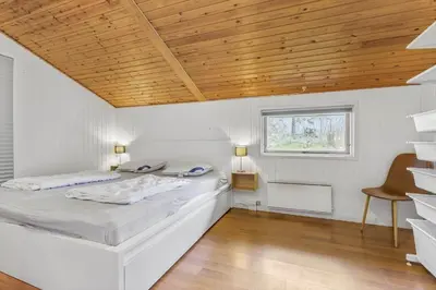 a bedroom with a bed and a wooden ceiling at JB118-Fjerritslev-Ahornvej-8 in Fjerritslev