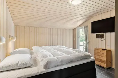 a large white bed in a room with a television at JB139-Fjerritslev-Kastanievej-13 in Fjerritslev
