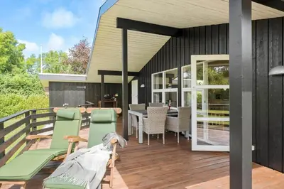 a patio with chairs and a table on a deck at JB139-Fjerritslev-Kastanievej-13 in Fjerritslev