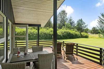 a patio with a table and chairs on a deck at JB139-Fjerritslev-Kastanievej-13 in Fjerritslev