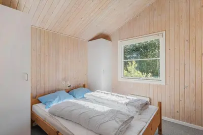 a bedroom with a bed in a room with a window at JB293-Fjerritslev-Tyttebaerstien-24 in Fjerritslev