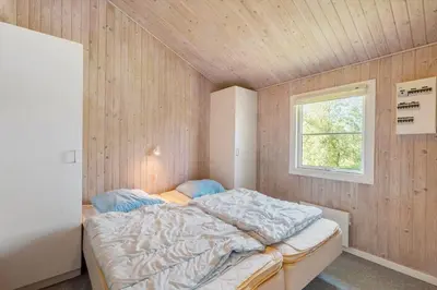 a bedroom with a bed in a room with a window at JB293-Fjerritslev-Tyttebaerstien-24 in Fjerritslev