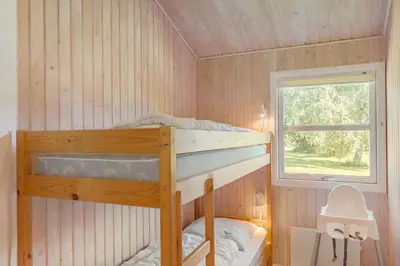 a bunk bed in a room with a window at JB293-Fjerritslev-Tyttebaerstien-24 in Fjerritslev