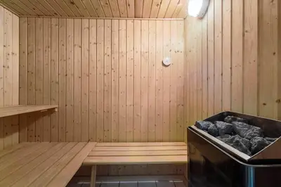 a sauna with a tub with rocks in it at JB293-Fjerritslev-Tyttebaerstien-24 in Fjerritslev