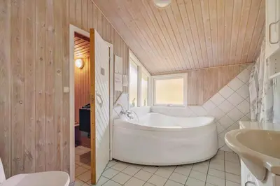 a bathroom with a large tub and a sink at JB293-Fjerritslev-Tyttebaerstien-24 in Fjerritslev