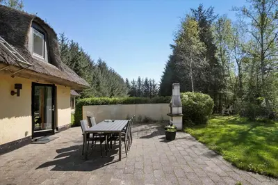 a patio with a table and chairs next to a house at JB186-Fjerritslev-Gyvelstien-27 in Fjerritslev