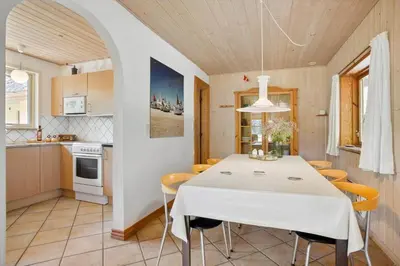 a kitchen and dining room with a white table and chairs at JB186-Fjerritslev-Gyvelstien-27 in Fjerritslev
