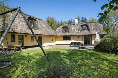 a large yellow house with a thatched roof at JB186-Fjerritslev-Gyvelstien-27 in Fjerritslev