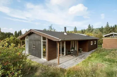 a small house with a deck in a field at JB242-Fjerritslev-Poppelvej-8 in Fjerritslev