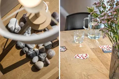 a table with rocks and a vase of flowers and a table with a glass at JB242-Fjerritslev-Poppelvej-8 in Fjerritslev