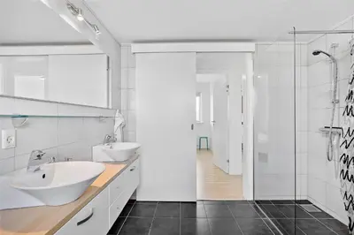 a white bathroom with two sinks and a shower at JB140-Frostrup-Svenstibakkevej-68 in Frøstrup