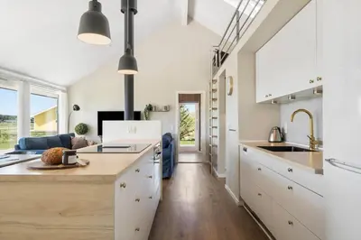 a kitchen with white cabinets and a large island at JB214-Brovst-Kronvildtvej-214 in Brovst