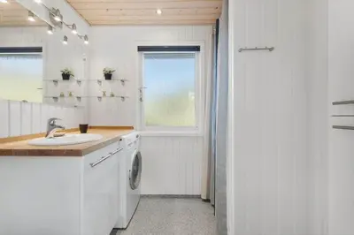 a white bathroom with a sink and a window at JB219-Fjerritslev-Tyttebaerstien-4 in Fjerritslev