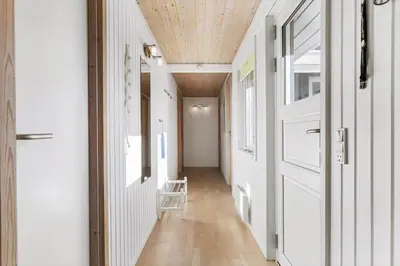 a hallway with white walls and a wooden ceiling at JB219-Fjerritslev-Tyttebaerstien-4 in Fjerritslev