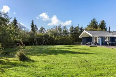 a yard with a house and a playground at JB219-Fjerritslev-Tyttebaerstien-4 in Fjerritslev