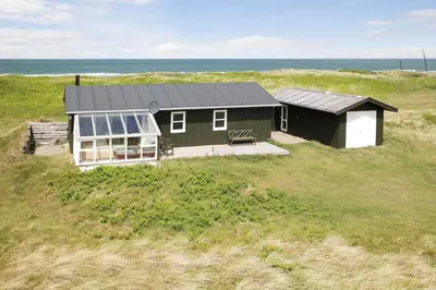 a green house with a solarium on a beach at JB109-Frostrup-Strandkaervej-8 in Frøstrup