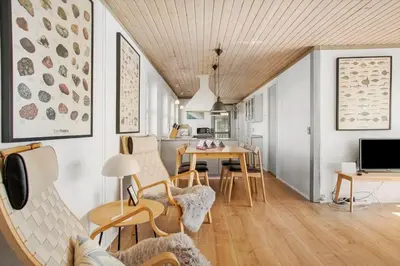 a living room with a table and chairs at JB109-Frostrup-Strandkaervej-8 in Frøstrup