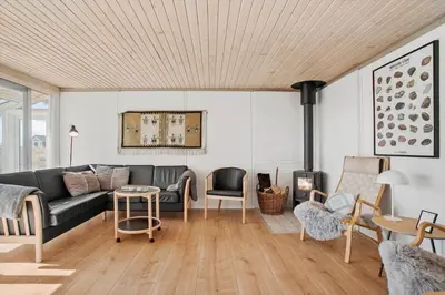 a living room with a couch and a table at JB109-Frostrup-Strandkaervej-8 in Frøstrup