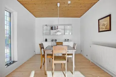 a dining room with a table and chairs at JB148-Fjerritslev-Svinklovvej-107 in Fjerritslev