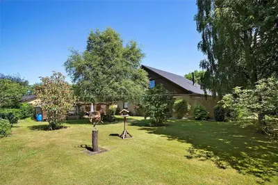 a house with a yard with two objects in the grass at JB148-Fjerritslev-Svinklovvej-107 in Fjerritslev