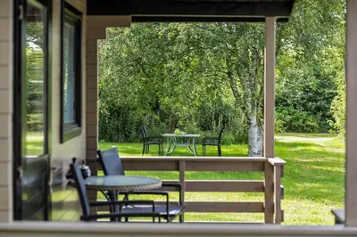 a patio with a table and chairs on a porch at JB273-Fjerritslev-Hasselvej-39 in Fjerritslev